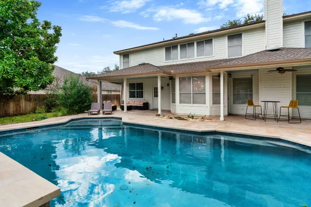 a view of a house with swimming pool and porch