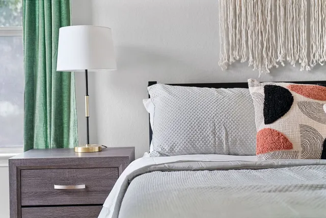 a bedroom with a bed and a lamp