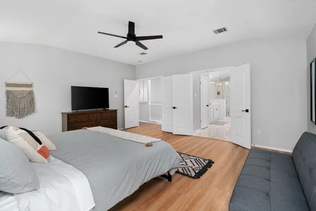 a bedroom with a bed and a flat screen tv