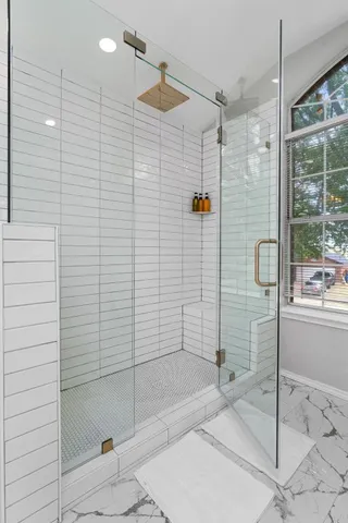 a bathroom with a shower and a sink