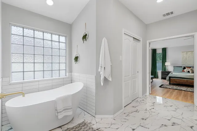 a spacious bathroom with a bathtub and toilet