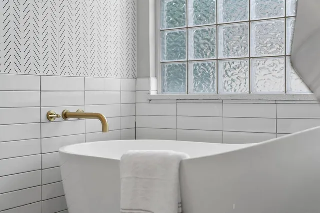 a bathroom with a bathtub and window