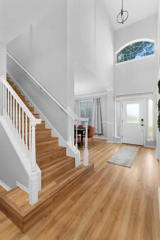 a view of an entryway with wooden floor