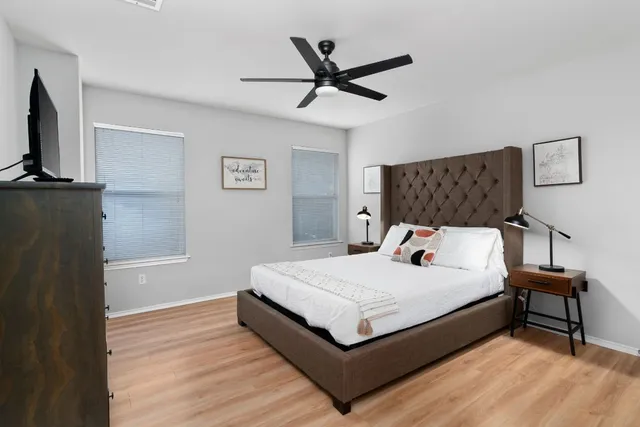 a bedroom with a bed and a tv