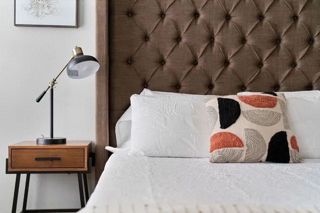 a bedroom with a bed and a table in it