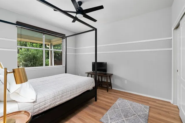 a bedroom with a bed and a table