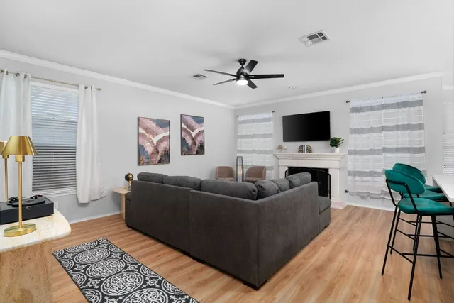 a living room with furniture and a flat screen tv