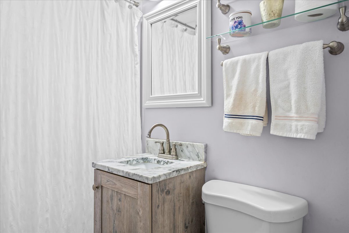 1425 Brophy Avenue Park Ridge, IL 60068 - Photo 11 of 24 a bathroom with a granite countertop sink and a toilet