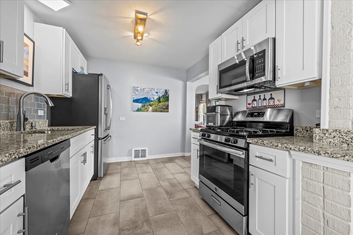 1425 Brophy Avenue Park Ridge, IL 60068 - Photo 7 of 24 a kitchen with stainless steel appliances granite countertop a stove top oven a sink dishwasher and a refrigerator