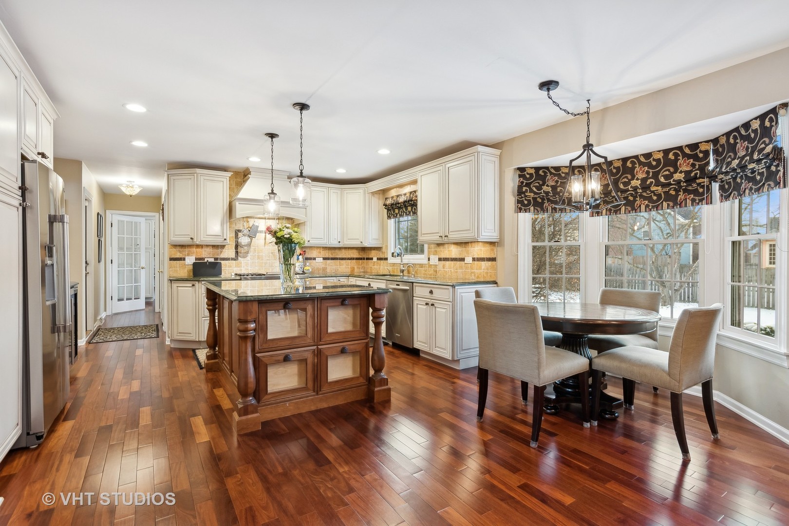 68 Citation Circle Wheaton, IL 60189 - Photo 4 of 38 a view of a dining room and livingroom with furniture wooden floor a chandelier