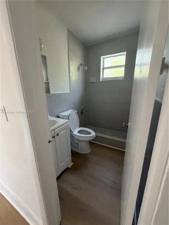 a bathroom with a sink a toilet a shower a mirror