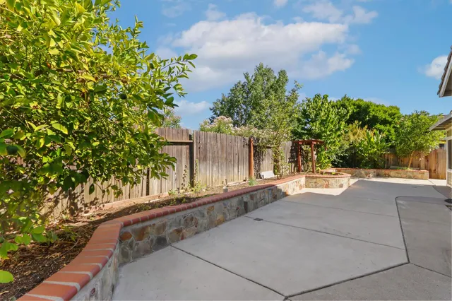 a kitchen with granite countertop a sink and a stove top oven