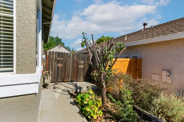 a view of empty room with wooden floor and windows