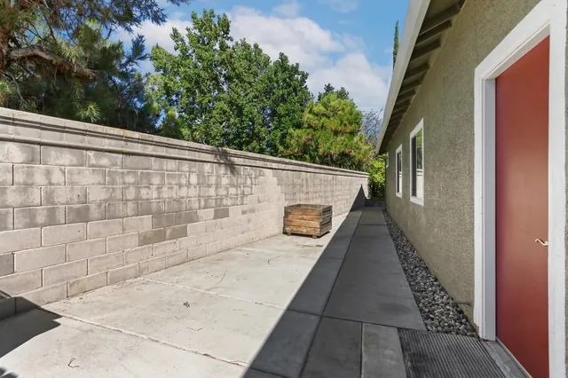 a backyard of a house with garden and patio