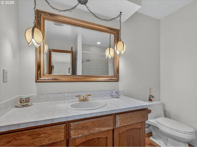a bathroom with a sink a toilet and shower curtain