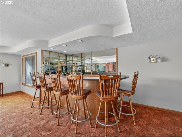 an empty room with fireplace wooden floor and windows