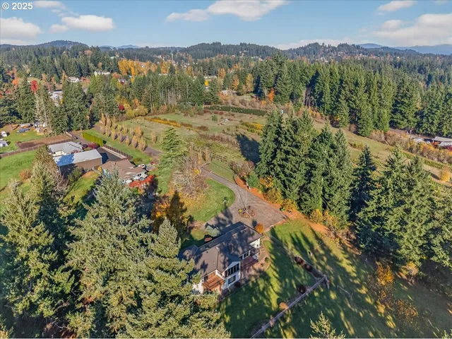 a backyard of a house with a yard and outdoor seating