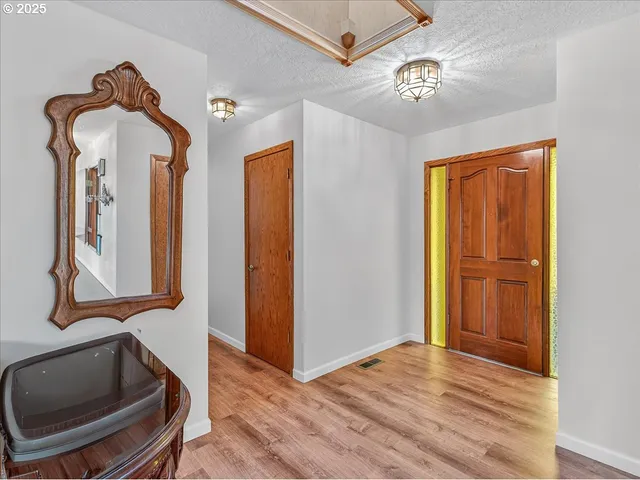 a living room with furniture fireplace and a large window