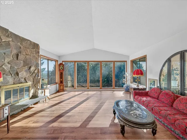 a living room with furniture a rug and a large window