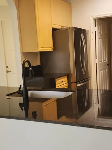 a kitchen with a refrigerator and a stove