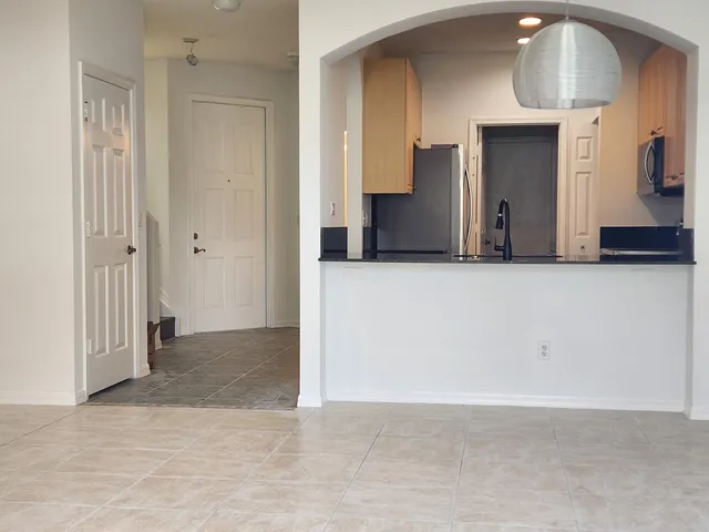 a view of a kitchen with a refrigerator and a sink