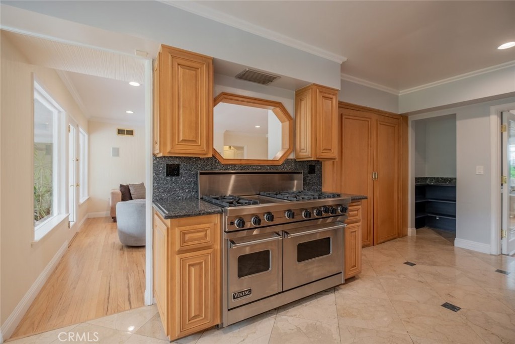 15363 Victory Boulevard Van Nuys, CA 91406 - Photo 14 of 52 a kitchen with stove top oven and cabinets