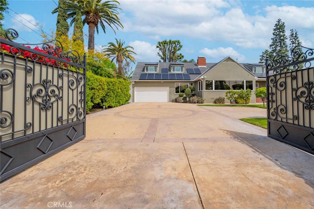 15363 Victory Boulevard Van Nuys, CA 91406 - Photo 2 of 52 a front view of a house with a yard and potted plants
