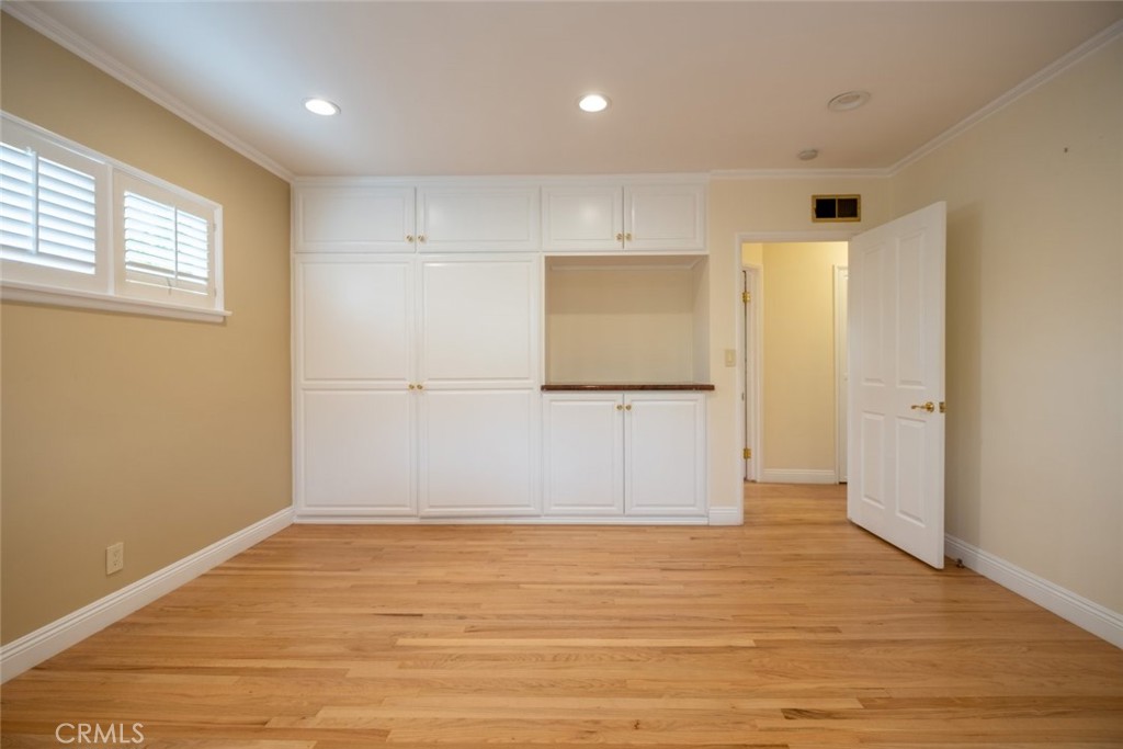 15363 Victory Boulevard Van Nuys, CA 91406 - Photo 23 of 52 wooden floor in an empty room with a window