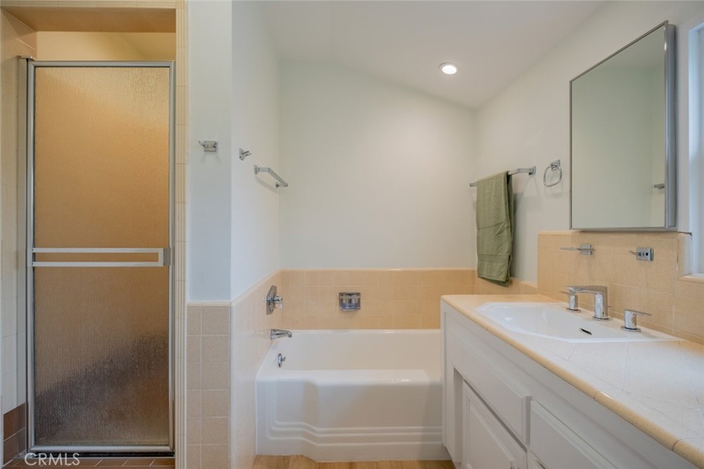 15363 Victory Boulevard Van Nuys, CA 91406 - Photo 33 of 52 a bathroom with a tub sink and mirror