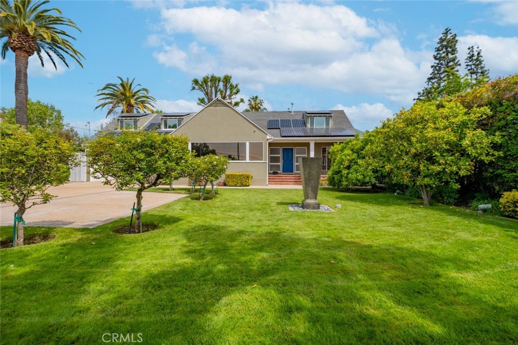 15363 Victory Boulevard Van Nuys, CA 91406 - Photo 4 of 52 a front view of a house with garden