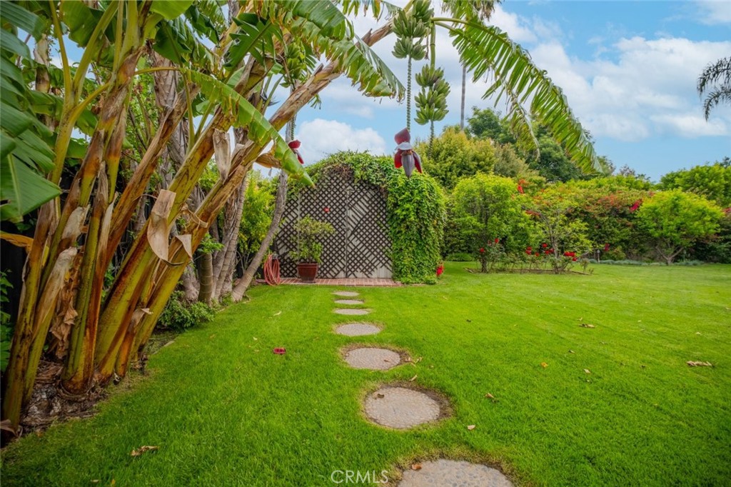 15363 Victory Boulevard Van Nuys, CA 91406 - Photo 49 of 52 a view of yard with swimming pool and lawn chairs under large trees