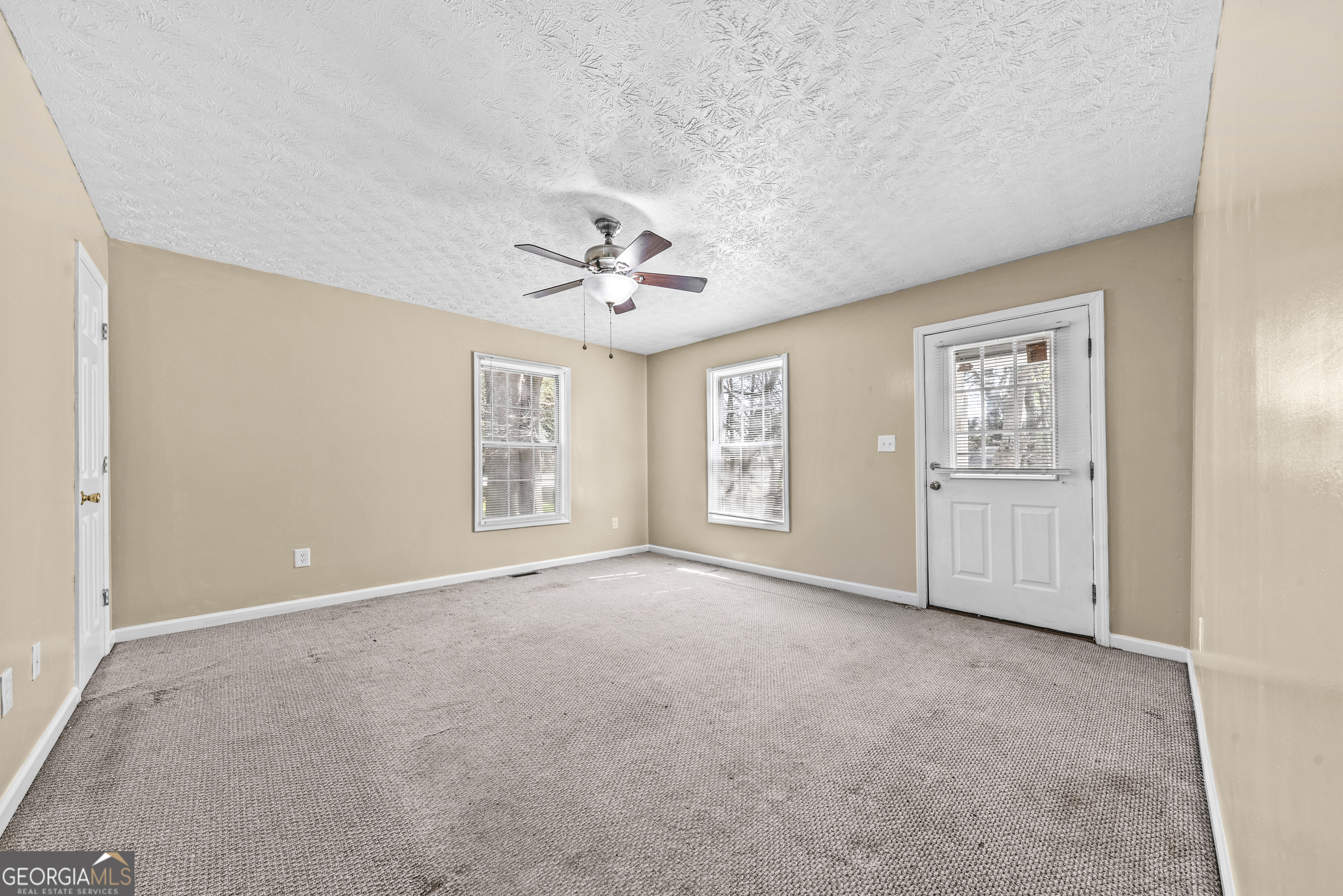 517 Gilmore Street Madison, GA 30650 - Photo 11 of 34 a view of an empty room with windows