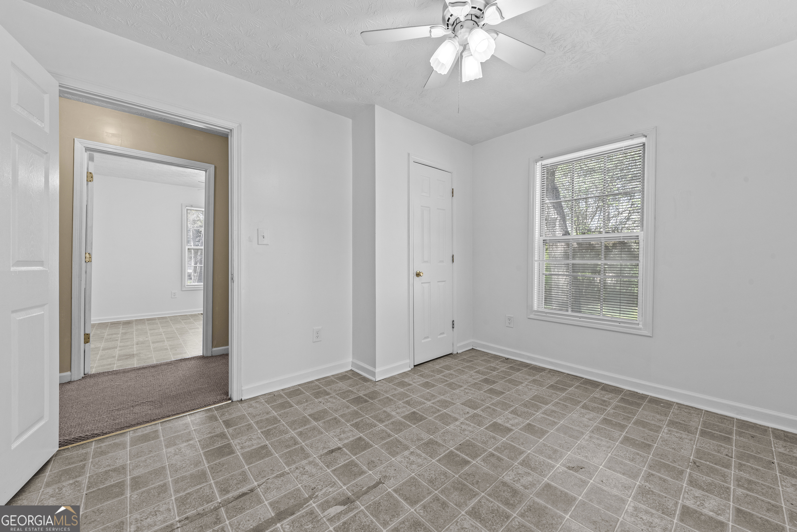 517 Gilmore Street Madison, GA 30650 - Photo 19 of 34 a view of an empty room with window and chandelier fan
