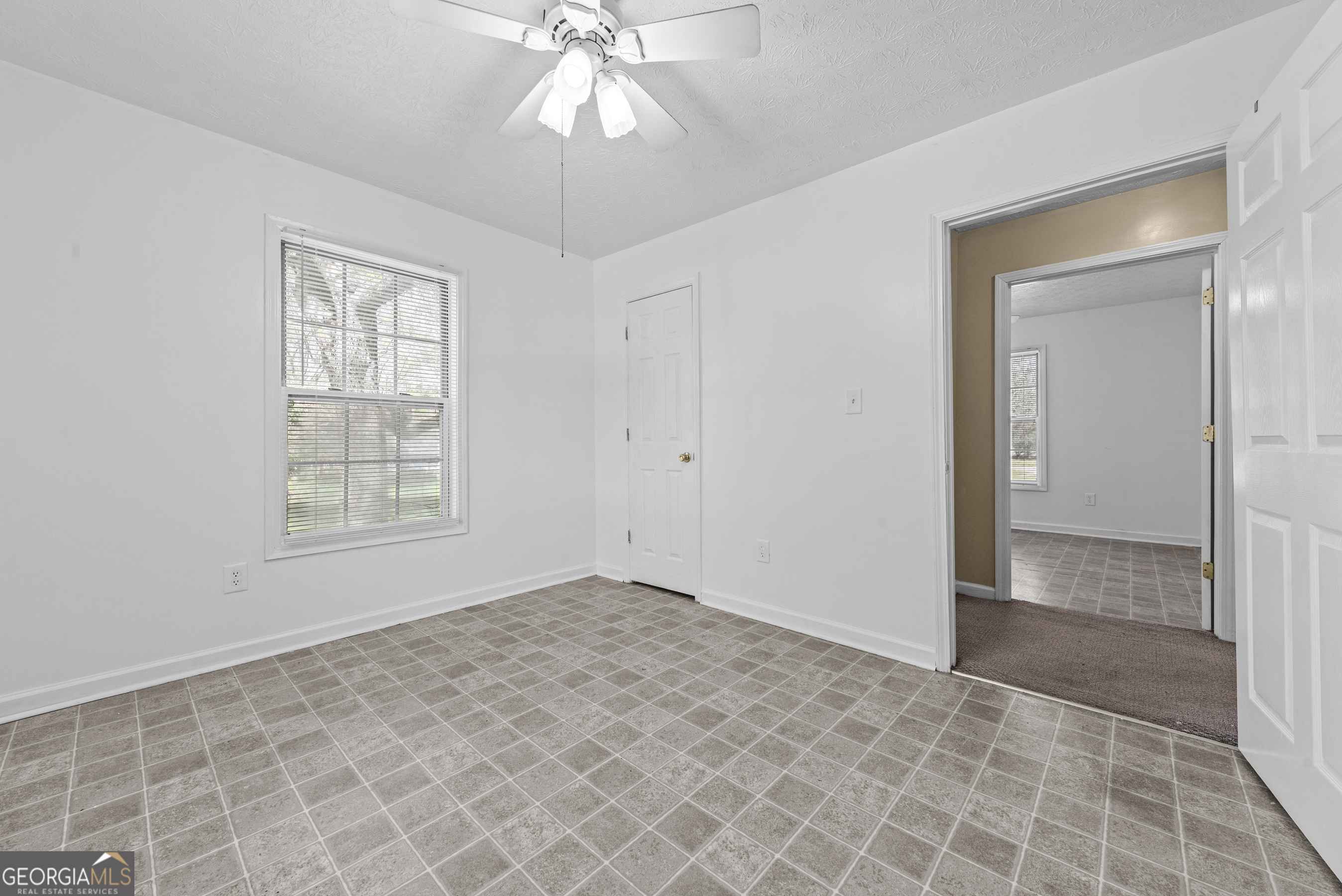 517 Gilmore Street Madison, GA 30650 - Photo 22 of 34 an empty room with fan and windows