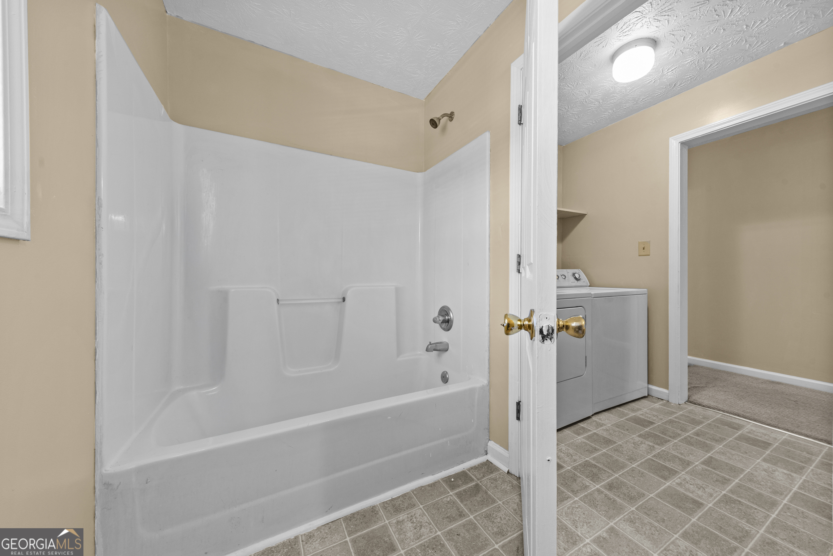 517 Gilmore Street Madison, GA 30650 - Photo 26 of 34 a bathroom with a bathtub and a shower