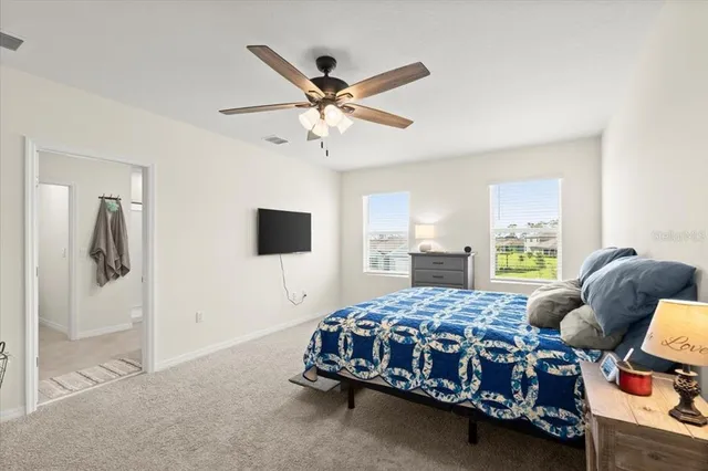 a bedroom with a bed a window and couch