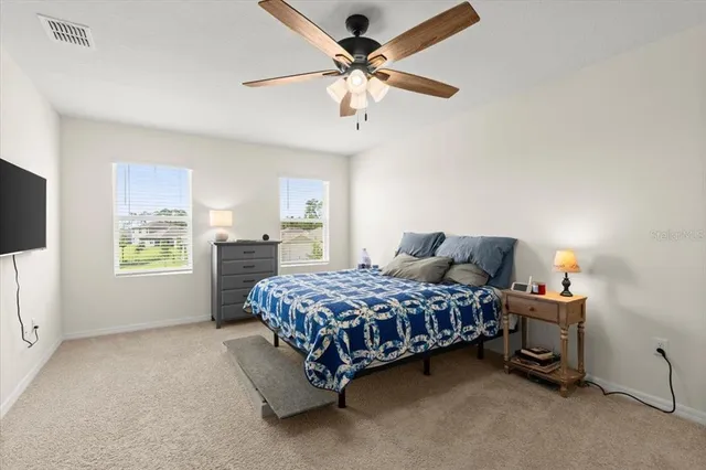 a bedroom with a bed dresser and a window