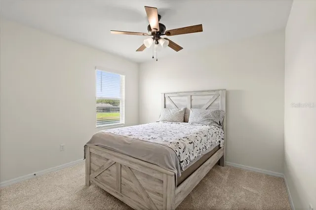 a bedroom with a bed and window