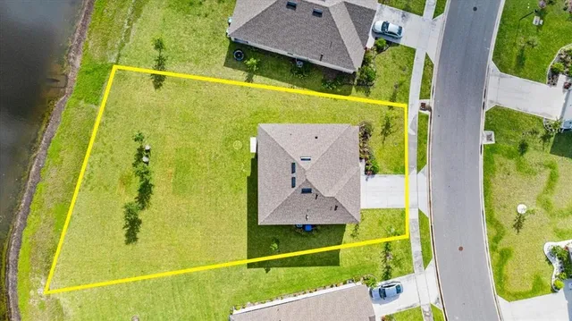 an aerial view of a house with a swimming pool yard and outdoor seating