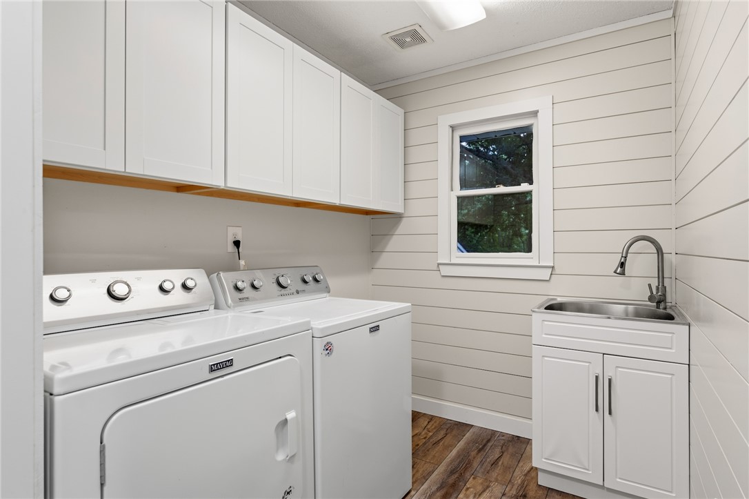 1014 East Queen Street Pendleton, SC 29670 - Photo 17 of 43 Functional laundry room includes ample cabinetry, a utility sink, and durable wood-look flooring.