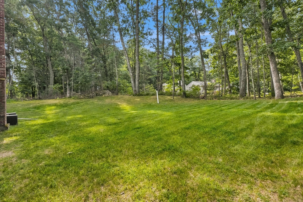11 Marlboro Road Georgetown, MA 01833 - Photo 37 of 42 a backyard of a house with lots of green space and garden