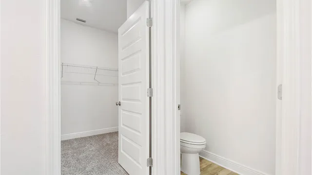a bathroom with a granite countertop toilet and a shower