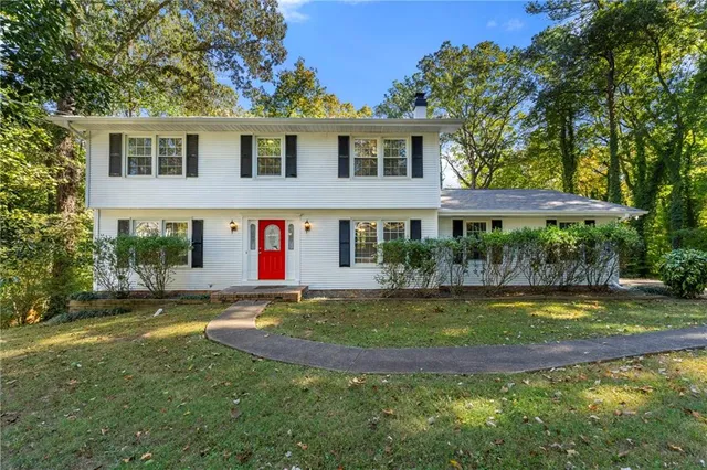 a view of a house with a yard and sitting area