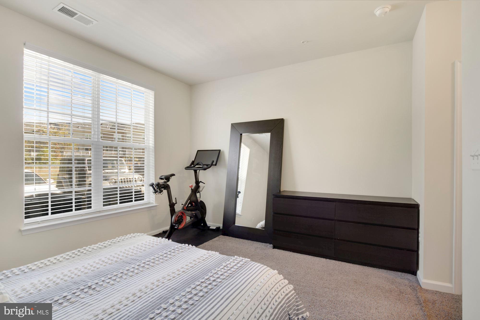 3825 Doc Berlin Drive, Unit 17 Silver Spring, MD 20906 - Photo 18 of 34 a bedroom with a bed and a window