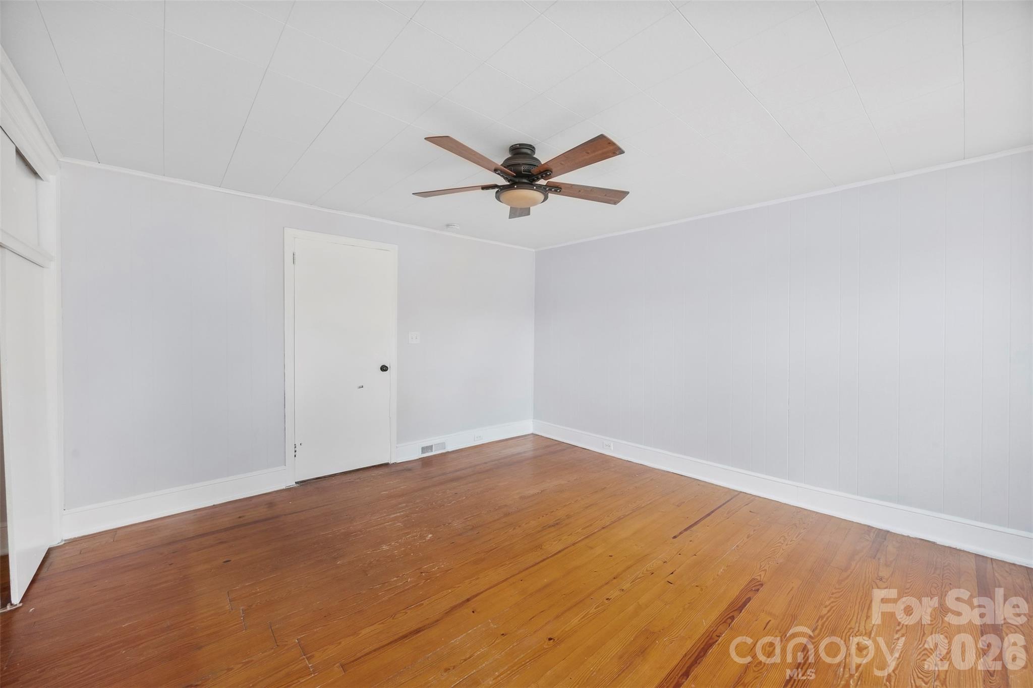 302 South Maple Street Dallas, NC 28034 - Photo 12 of 25 an empty room with a ceiling fan and a window