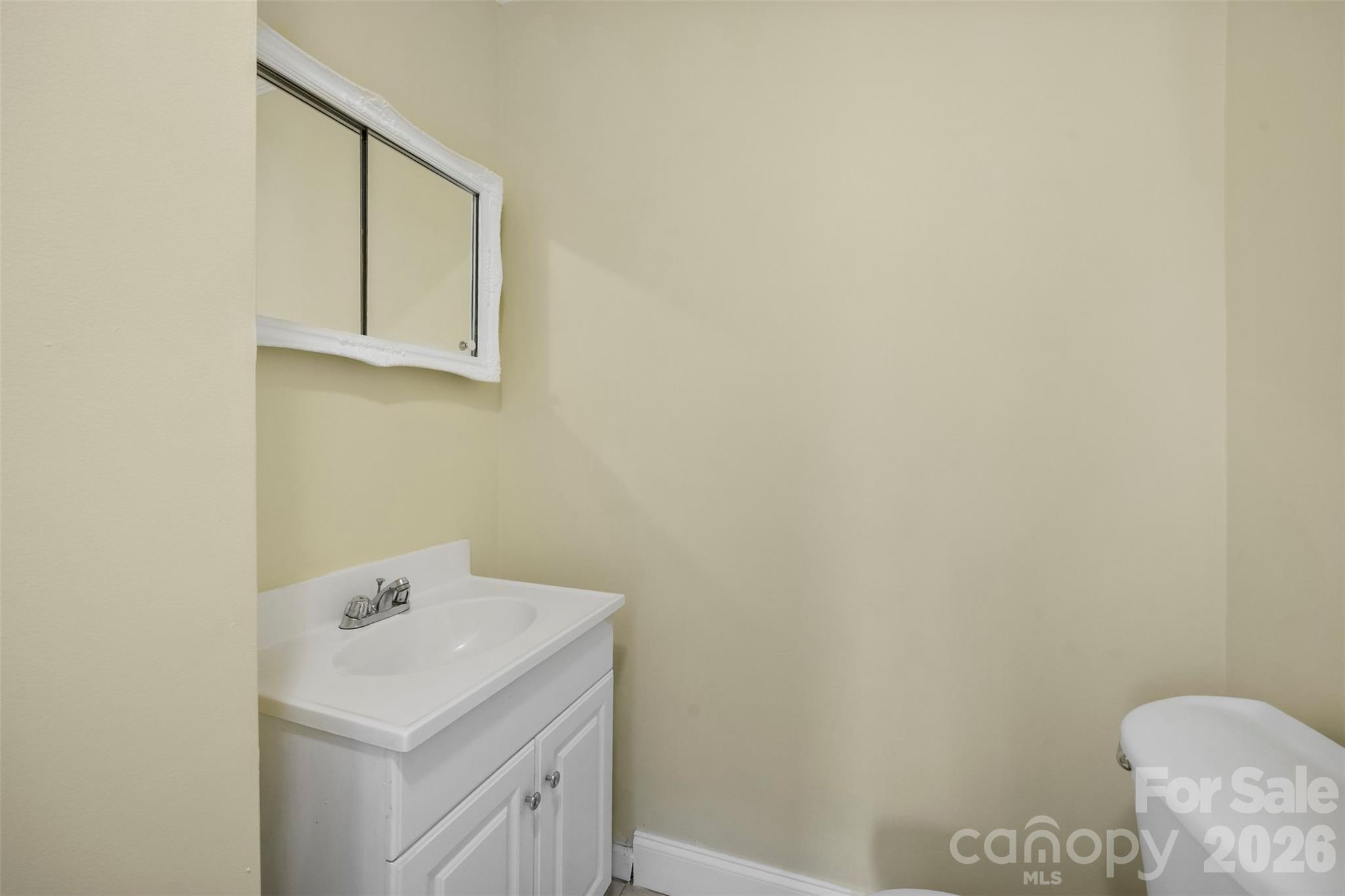 302 South Maple Street Dallas, NC 28034 - Photo 13 of 25 a bathroom with a sink and mirror