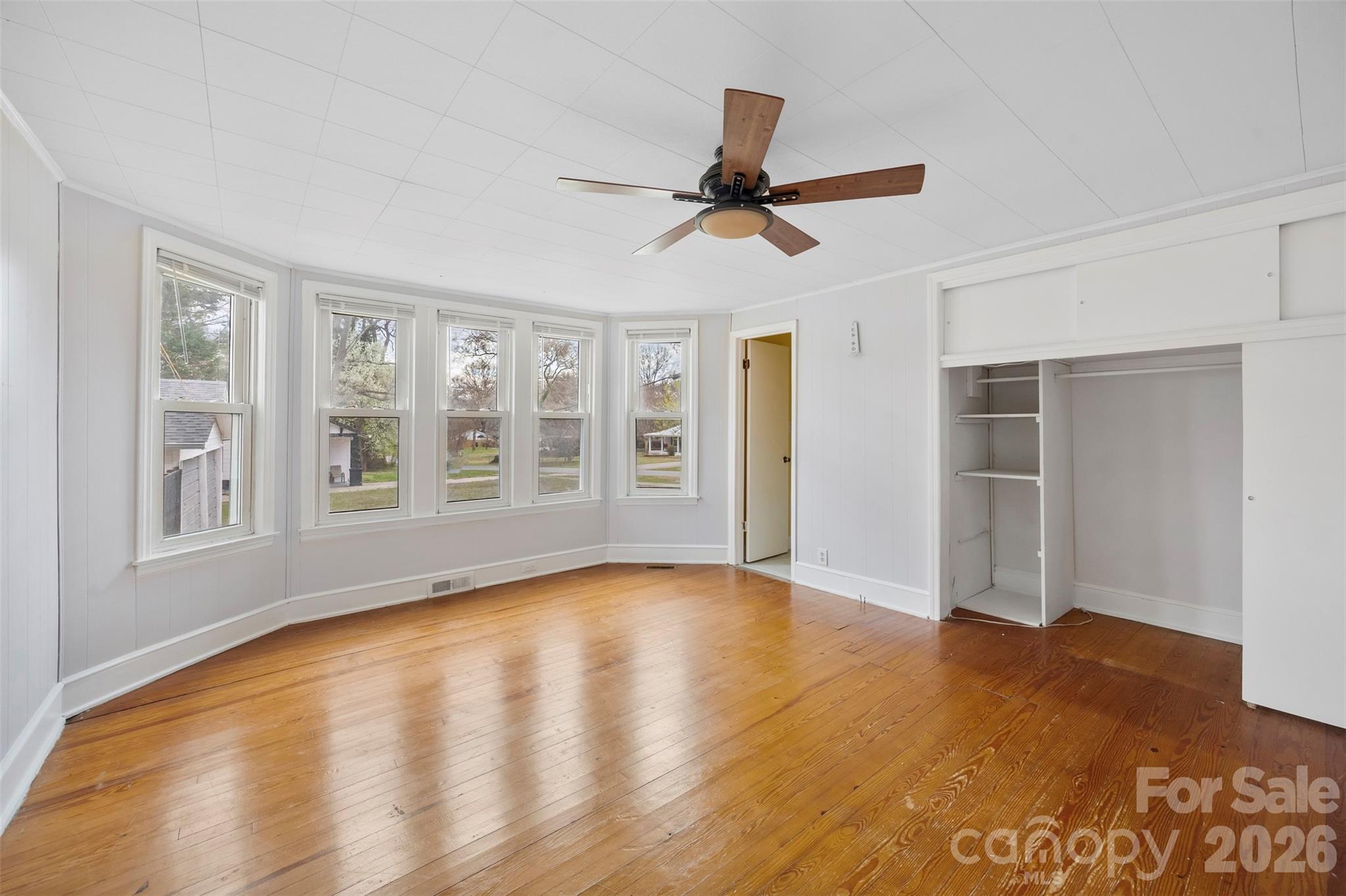 302 South Maple Street Dallas, NC 28034 - Photo 14 of 25 a view of an empty room with window and wooden floor