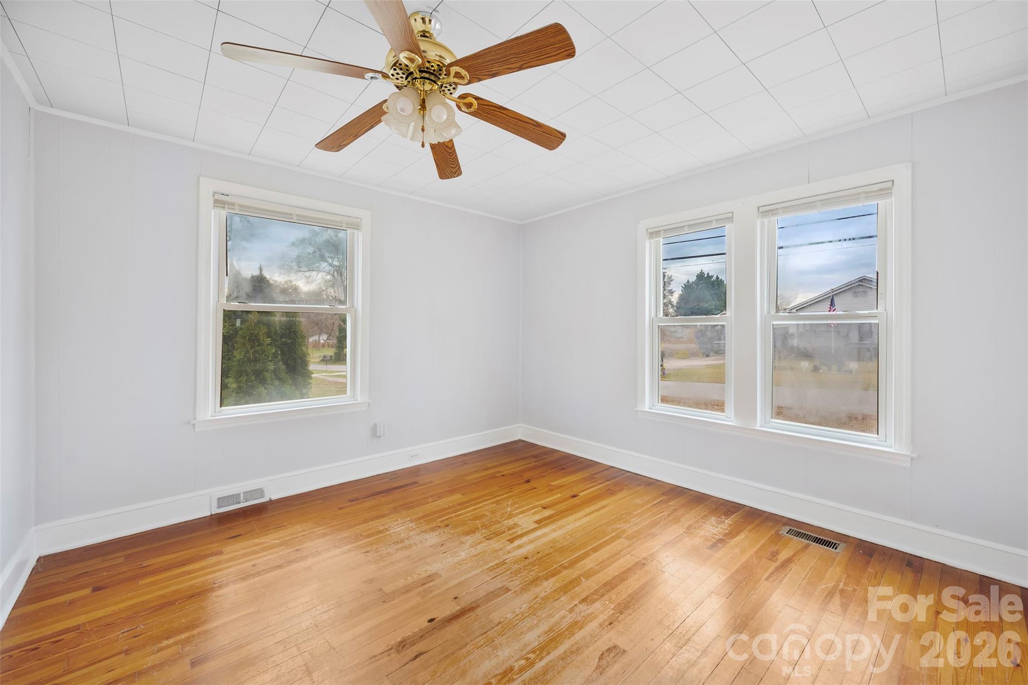 302 South Maple Street Dallas, NC 28034 - Photo 15 of 25 a view of an empty room with a window and wooden floor