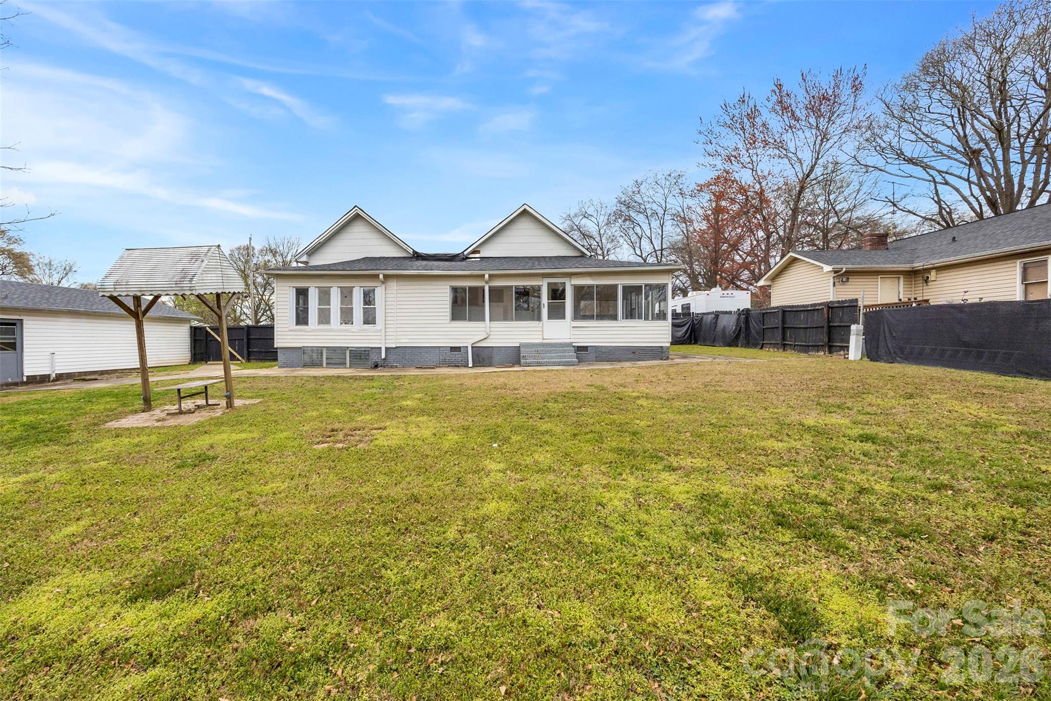 302 South Maple Street Dallas, NC 28034 - Photo 23 of 25 a view of a house with a big yard and large trees