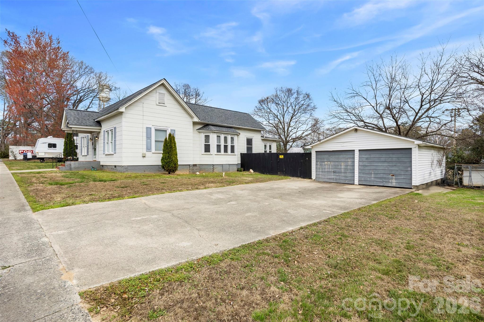 302 South Maple Street Dallas, NC 28034 - Photo 4 of 25 a front view of a house with a yard and garage